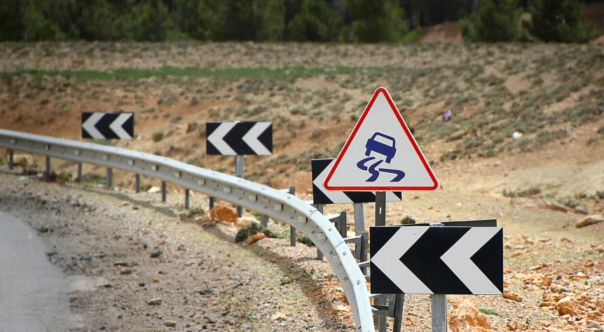 a couple of road signs sitting on the side of a road, by Telemaco Signorini, precisionism, costa blanca, cars crashed, lavs flowing through the land, skidding