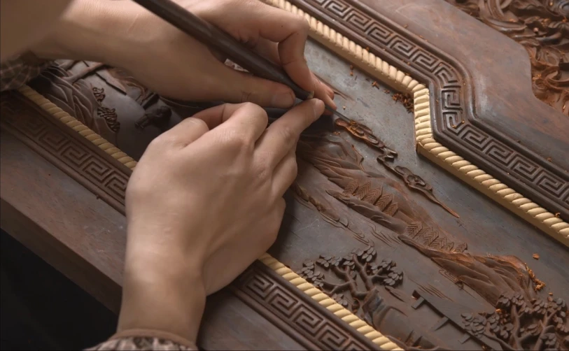 a close up of a person carving a piece of wood, an ultrafine detailed painting, trending on zbrush central, cloisonnism, documentary still, chocolate art, intricate writing, intricate scenery