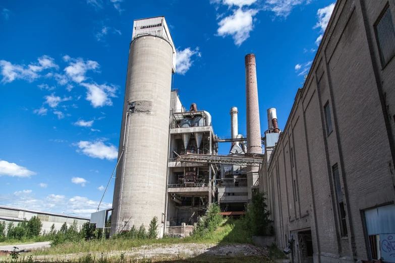 a factory with a lot of smoke coming out of it, bauhaus, huge giant old ruins, summer day, yeg, cement