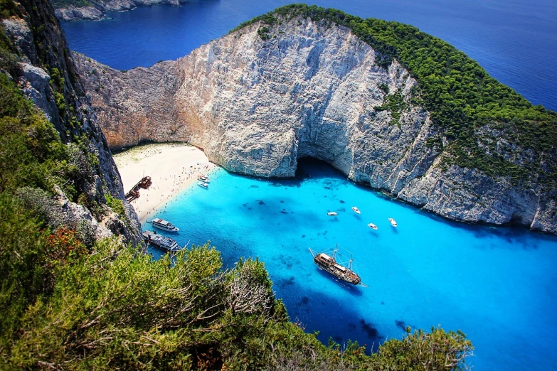 a boat that is sitting in the water, a picture, by Alexander Bogen, shutterstock, greek fantasy panorama, breath-taking beautiful beach, shot from above, bright blue glowing water