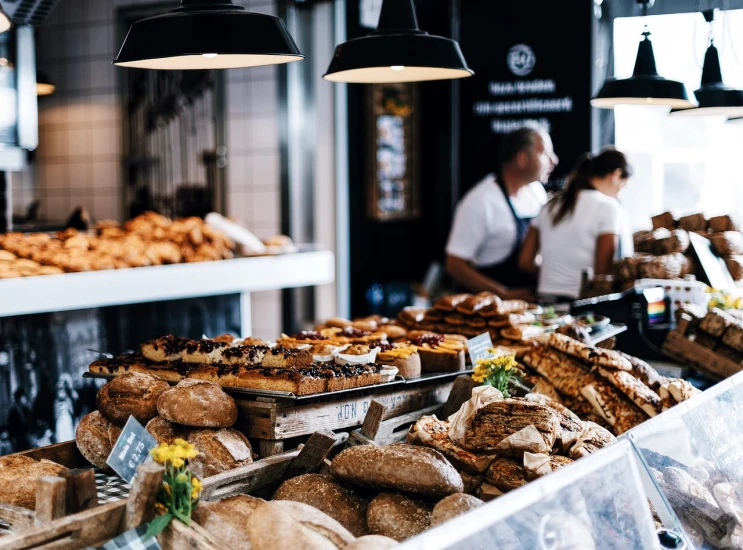 a bakery filled with lots of different types of bread, by Niko Henrichon, pexels, people inside eating meals, 🦩🪐🐞👩🏻🦳, scandinavian, award - winning crisp details ”