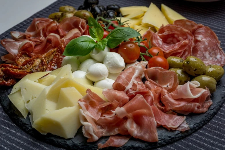 a close up of a plate of food on a table, by Carlo Martini, pexels, renaissance, cheese and pepperoni, 🦩🪐🐞👩🏻🦳, ham, slate