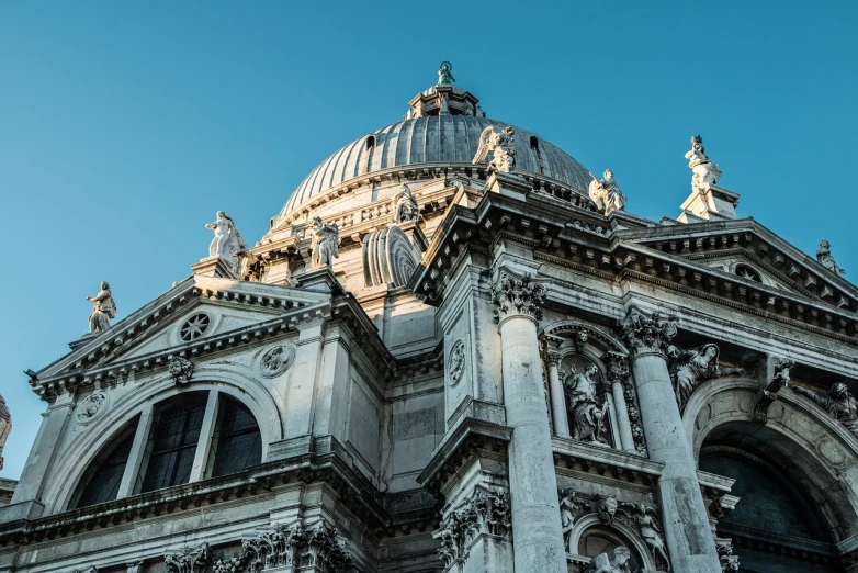 a very tall building with a clock on it's side, a marble sculpture, inspired by Christopher Wren, shutterstock, baroque, venice biennale, dome, morning light, view from bottom to top