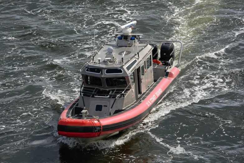 a red and black boat on a body of water, a portrait, shutterstock, scout police robot, usa-sep 20, high quality product image”