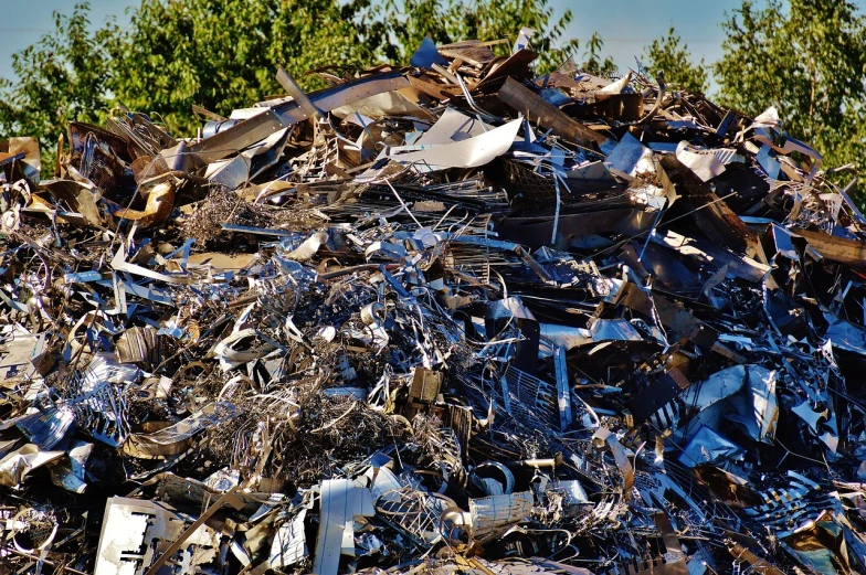 a pile of scrap metal with trees in the background, a photo, plasticien, mid morning lighting, hdr!, ebay photo, confetti