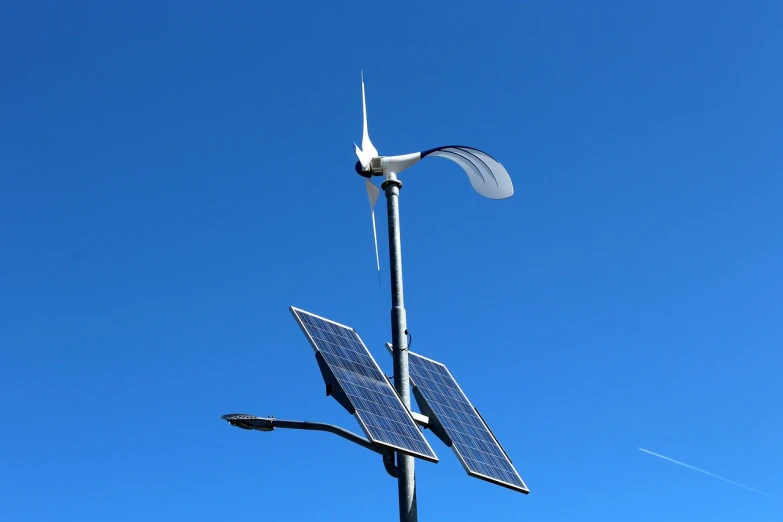 a wind turbine on top of a pole next to a street light, by Edward Corbett, covered solar system, closeup photo, solar punk product photo