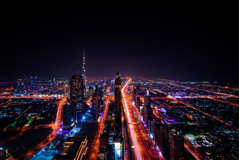 an aerial view of a city at night, by Alexander Robertson, pexels contest winner, dubai, vivid colours. sharp focus. wow!, timelapse, beautiful!!!!!!!!!!!!