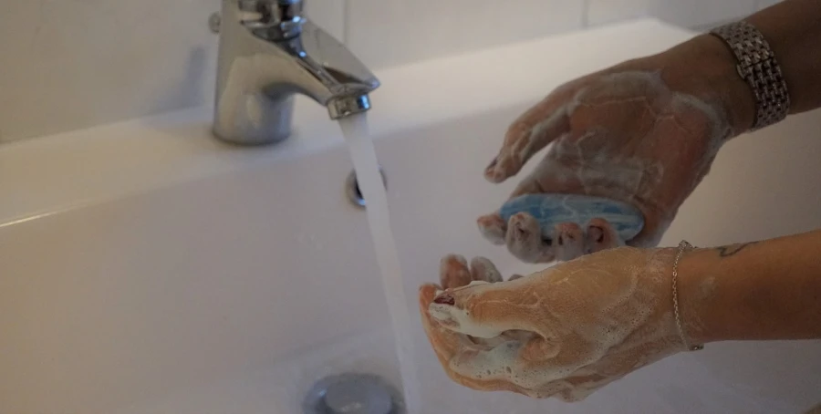 a person washing their hands with soap under a faucet, by Charlotte Harding, process art, realistic cloth puppet, anatomically correct hands, bubble bath, hands that are fox - paws