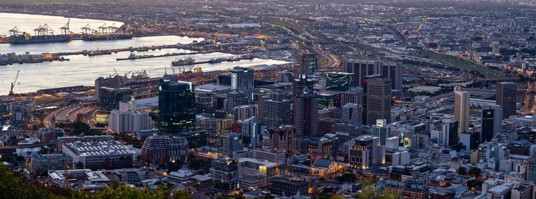 a view of a city from the top of a hill, by Lee Loughridge, pexels contest winner, cape, highly detail, 1 5 0 4, early evening