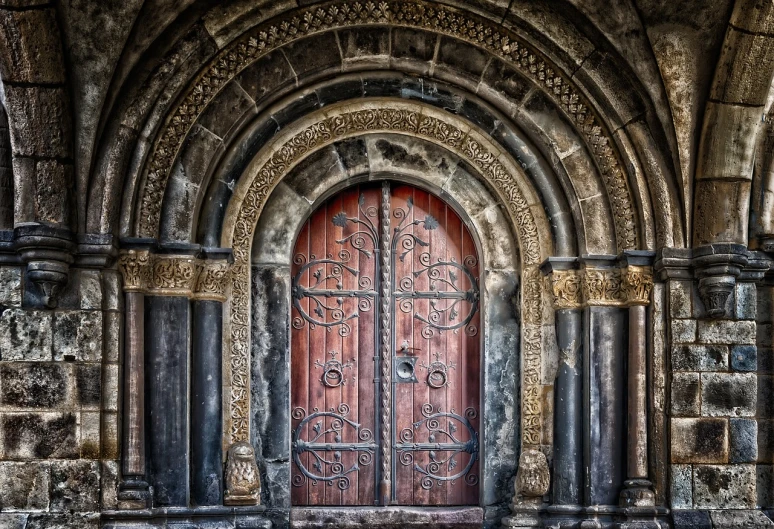 a large wooden door sitting inside of a stone building, by Itshak Holtz, shutterstock contest winner, romanesque, red and golden color details, celtic norse frankish, gothic library, hell gate