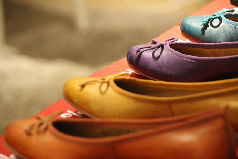 several pairs of shoes are stacked on top of each other, by Raphaël Collin, flickr, figuration libre, candy colors, warm hue's, product showcase, side-view