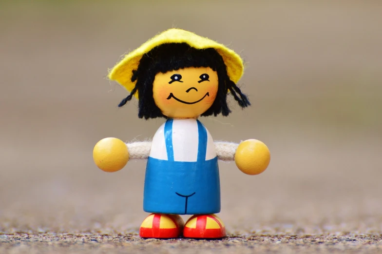 a close up of a toy with a hat on, a picture, pixabay contest winner, figuration libre, she is smiling and happy, a wooden, yellow and blue, japanesse farmer