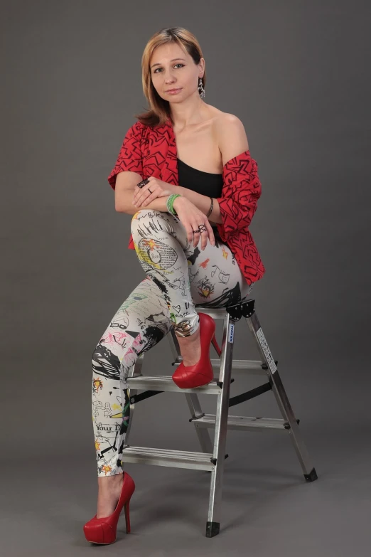 a woman sitting on top of a ladder, a portrait, inspired by Egon Schiele, flickr, graffiti, leggins, studio portrait photo, red high heels, jean and multicolor shoes