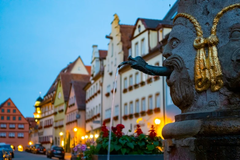 a close up of a fountain on a city street, a statue, by Matthias Weischer, shutterstock, a small medieval village, golden and blue hour, black forest, square