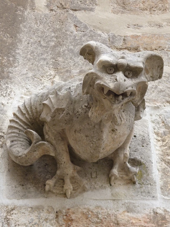 a statue of a dragon on the side of a building, by François Girardon, flickr, romanesque, anthropomorphic dog, cute little dragon, located in a castle, limestone