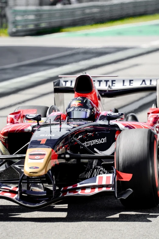 a close up of a racing car on a race track, by Thomas Häfner, shutterstock, red black and gold color scheme, red bull, paris 2010, stock photo