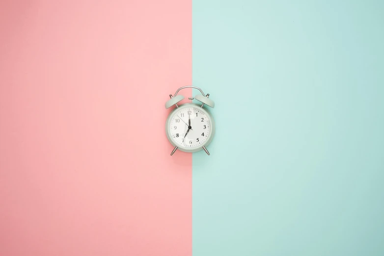 an alarm clock sitting on top of a pink and blue wall, postminimalism, perfect symmetrical image, teal silver red, miniature product photo, brown and cyan color scheme