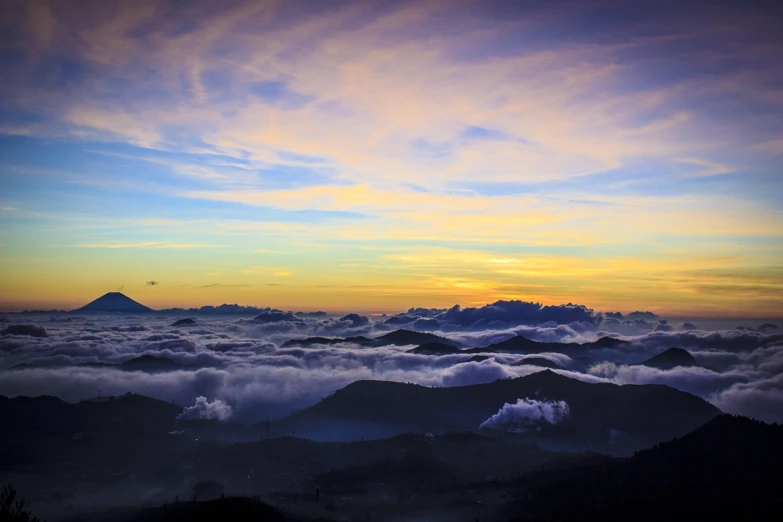 the sun is setting over the mountains above the clouds, a picture, shutterstock, sumatraism, (((colorful clouds))), morning mist, view from the top, night