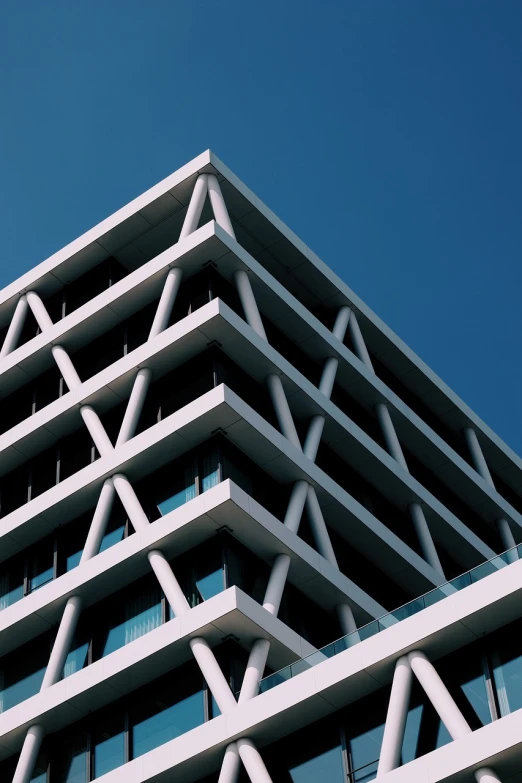 a very tall building with lots of windows, by Matthias Weischer, unsplash, brutalism, in triangular formation, in style of simplified realism, zig zag, dominant wihte and blue colours
