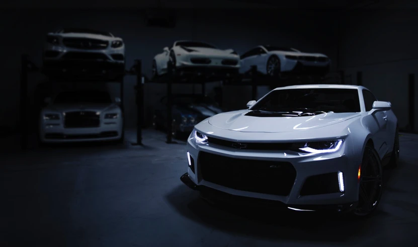 a close up of a car in a garage, inspired by An Gyeon, pexels contest winner, hypermodernism, white accent lighting, muscle cars, titanium white, dramatic lighting; 4k 8k