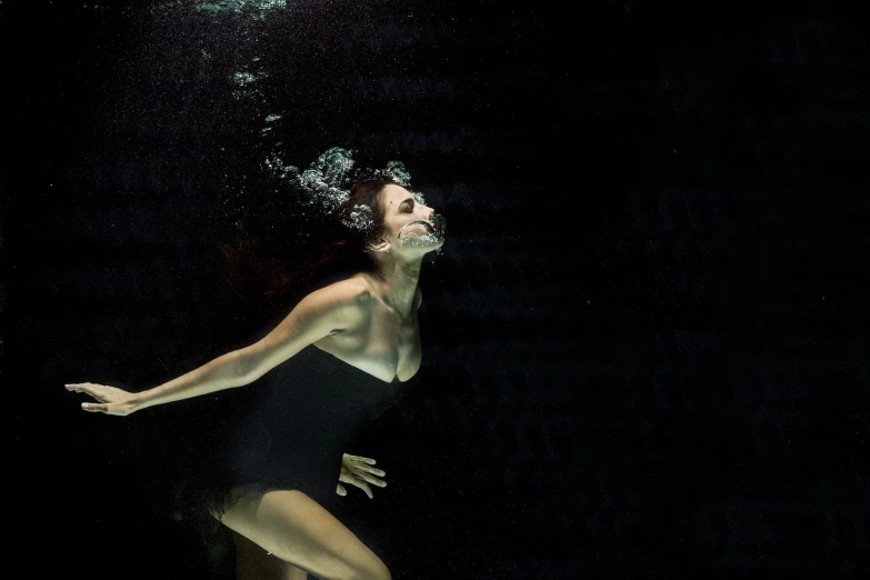 a woman in a black swimsuit under water, a portrait, unsplash, conceptual art, getty images, tony roberts, carole feuerman, phoebe tonkin