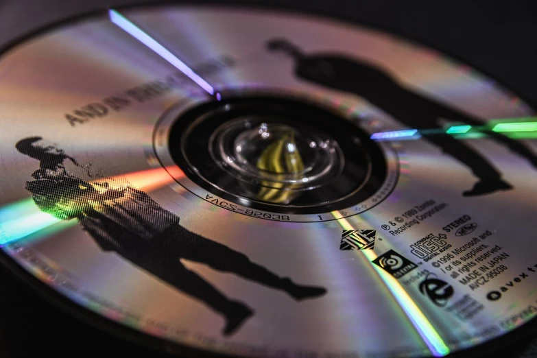 a close up of a cd on a table, by Jan Rustem, unsplash, holography, bottom view ， bladerunner, toy photo, shot on nikon d 3 2 0 0, unwind!