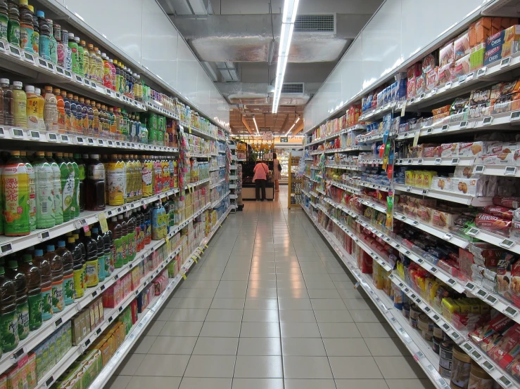 a store aisle filled with lots of different types of drinks, by Harold Elliott, pexels, hyperrealism, open shiny floor, getting groceries, slight overcast lighting, good face