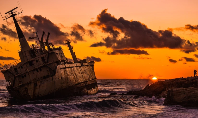 a boat sitting on top of a body of water, by Edwin Georgi, unsplash, romanticism, destroyed ship, orange dawn, profile shot, scylla and charybdis