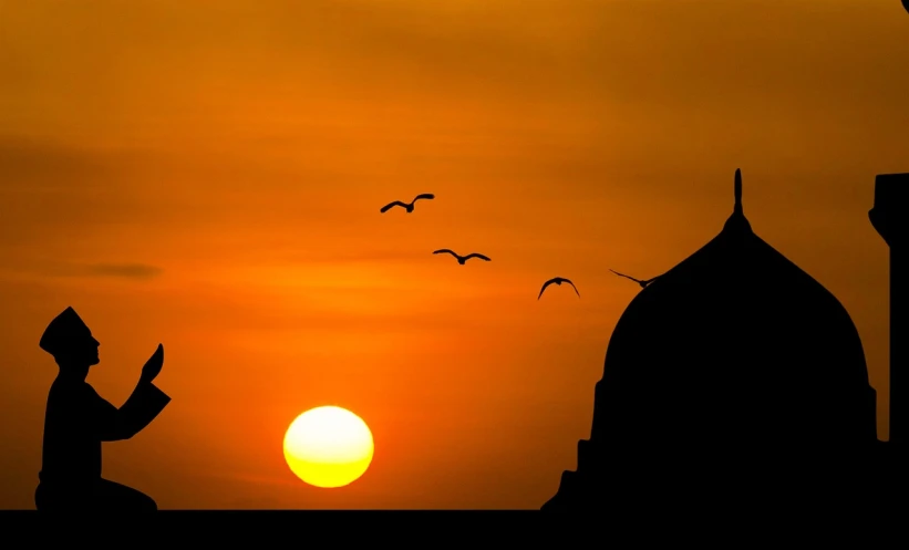 a silhouette of a man reading a book in front of a sunset, by Sudip Roy, minimalism, helicopters and tremendous birds, mosque, two suns, tourist photo