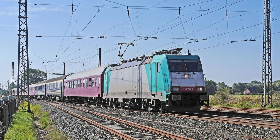 a large long train on a steel track, by Jens Søndergaard, flickr, mauve and cyan, budapest, nice colour scheme, locomotive