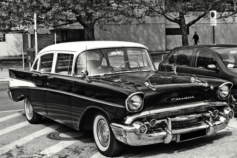 a black and white photo of a classic car, a black and white photo, inspired by Vivian Maier, trending on pixabay, photorealism, 1957 chevrolet bel air, highly contrasted colors, taxis, sepia