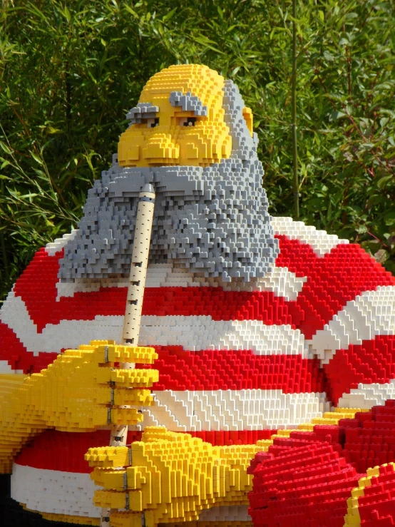 a lego statue of a man holding a baseball bat, inspired by Waldo Peirce, long beard, seaside, life size, edward buba