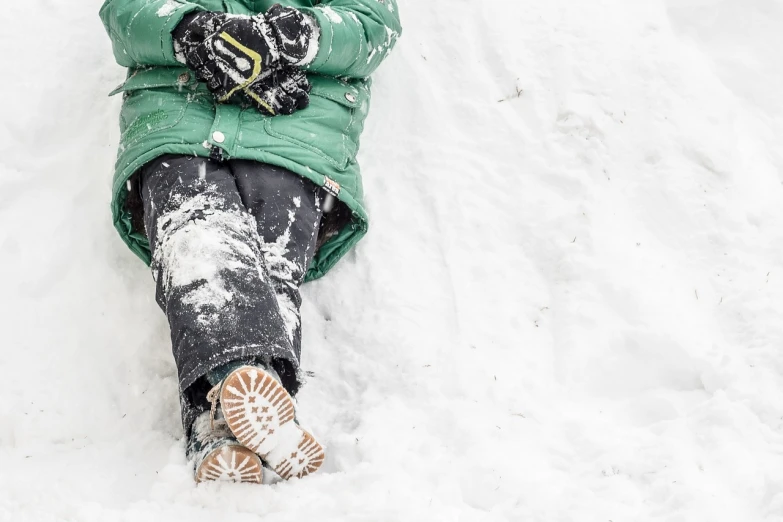 a child laying in the snow on a sled, by Mathias Kollros, pexels, figuration libre, green legs, hyperdetail, snowstorm ::5, mittens