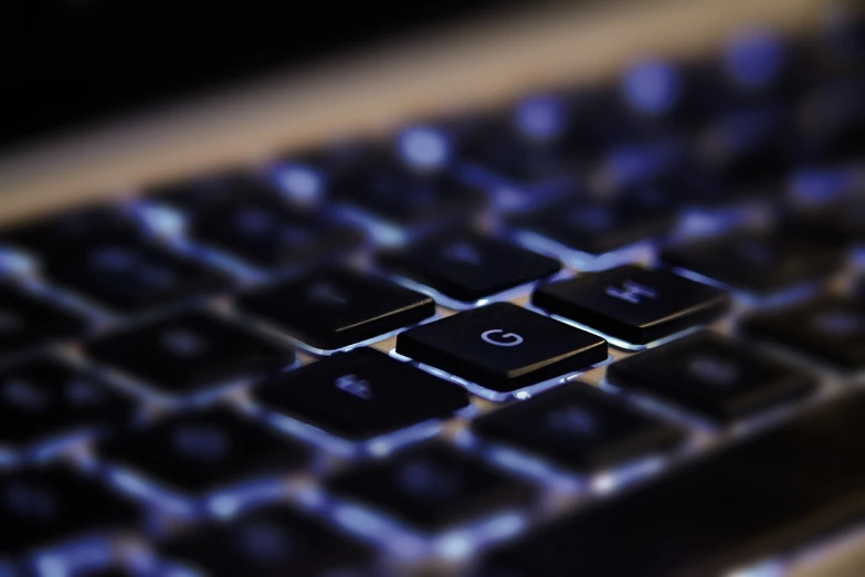 a close up of a keyboard with a blurry background, a computer rendering, glowing light and shadow, 4 k product photo