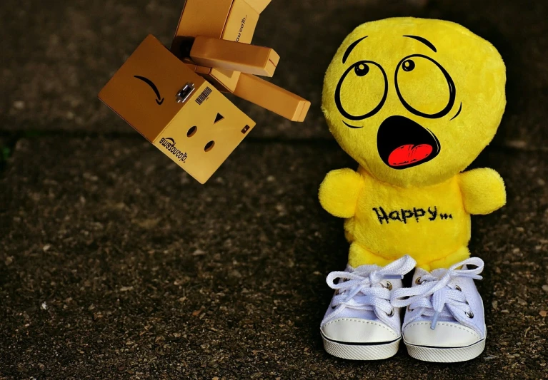a yellow stuffed animal standing next to a cardboard box, a picture, pixabay contest winner, graffiti, happy facial expression, sneaker photo, hopeless emotions, wallpapers