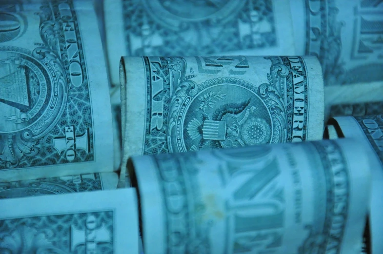 a bunch of money rolls sitting on top of each other, a stock photo, by Tom Carapic, 4 k close up, blue - print, (((intricate))), closeup headshot