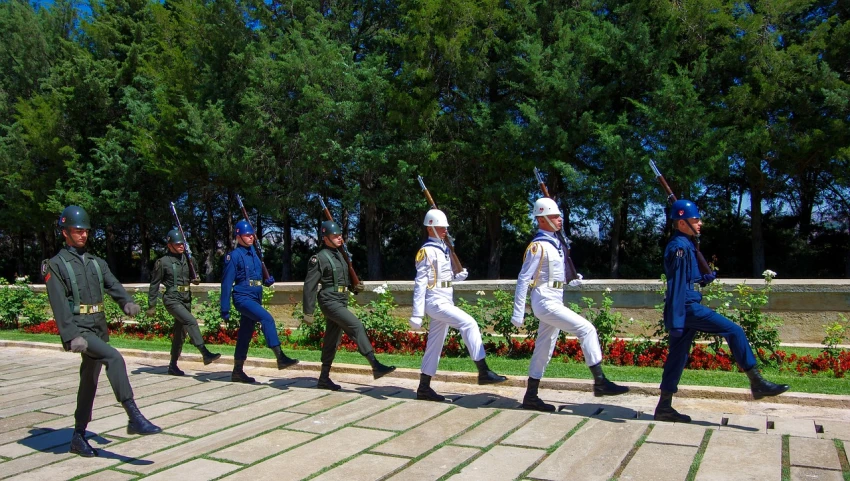 a group of men that are standing in the grass, by Fernando Gerassi, flickr, embroidered uniform guard, trampling over pyongyang, on a large marble wall, practising sword stances