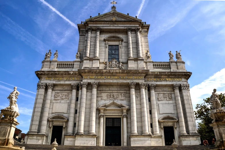 a large building with a clock on the front of it, inspired by Abraham van den Tempel, baroque, christian saint, gigantic pillars, italy, wide angle exterior 2022