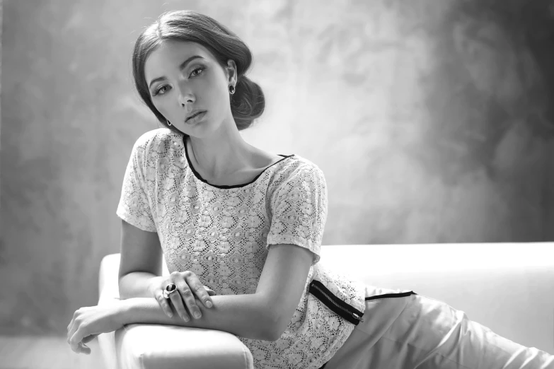 a black and white photo of a woman sitting on a couch, by Arthur Sarkissian, trending on pixabay, fine art, white lace clothing, li bingbing, chaumet style, style blend of the vatican