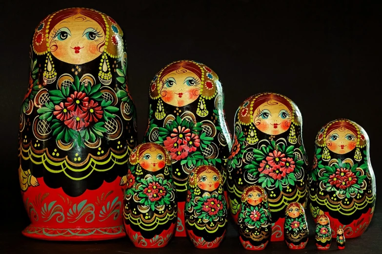 a group of matry dolls sitting next to each other, by Marie Bashkirtseff, trending on pixabay, qajar art, dark vibrant colors, glossy intricate design, perfect symmetrical image, stacked