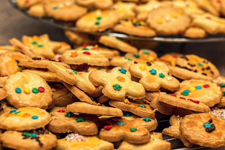 a table topped with lots of cookies covered in sprinkles, by Aleksander Gierymski, pexels, gold speckles, post-processed, 🎨🖌️, cutie