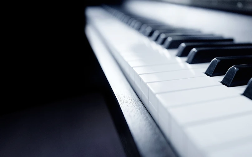 a close up of the keys of a piano, a macro photograph, by Adam Chmielowski, pixabay, minimalism, dominant wihte and blue colours, wide-screen, beautifully soft lit, dark and white