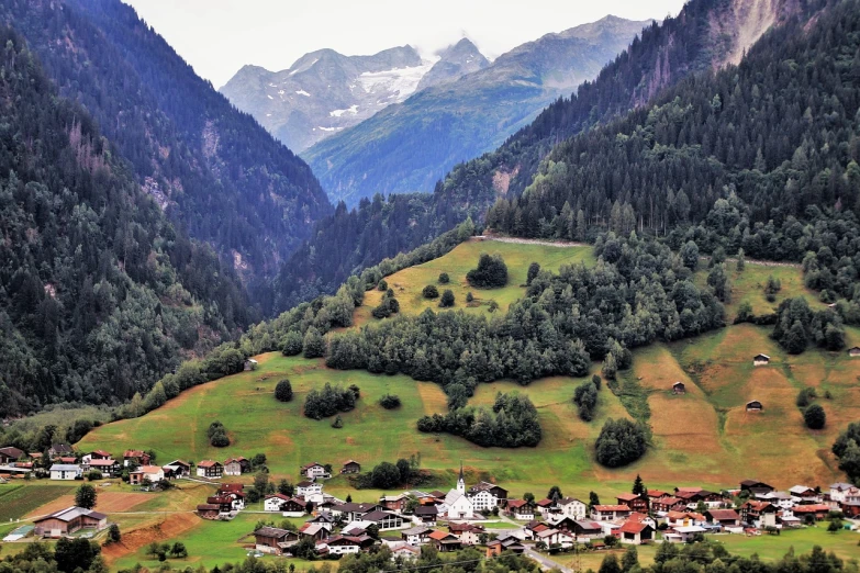 a view of a small village in the mountains, by Karl Gerstner, shutterstock, shot from 5 0 feet distance, evergreen valley, very detailed photo, high quality image”