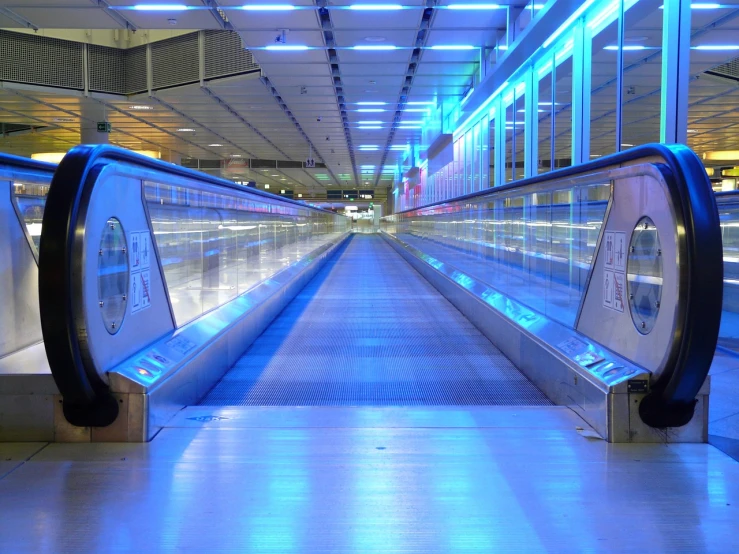 a close up of an escalator at an airport, by Edward Corbett, flickr, futurism, 1 glowing bridge crossing river, light-blue, alone!!, walkways