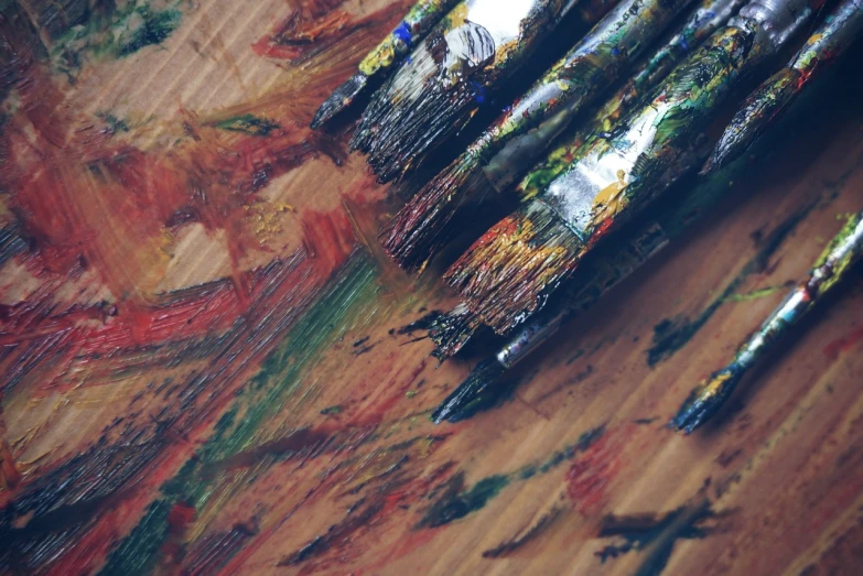 a bunch of paint brushes sitting on top of a wooden table, a detailed painting, inspired by Jules Olitski, pexels, action painting, beautiful art uhd 4 k, abstract impressionism, viewed from above, abstract painting oil on canvas