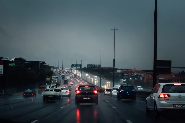 a bunch of cars that are driving down the street, by Etienne Delessert, pexels, hyperrealism, gloomy/wet atmosphere, freeway, thunderstorm in marrakech, 1505