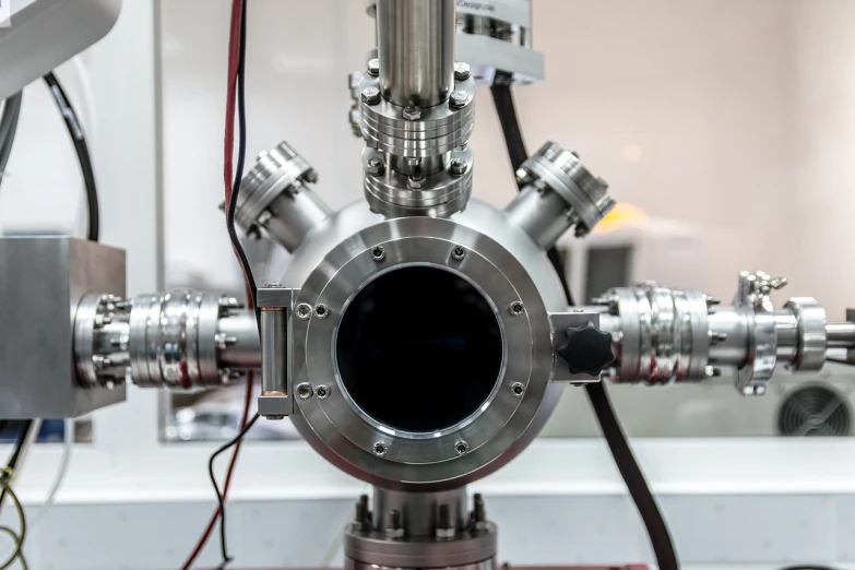 a close up of a metal object on a table, by Jakob Gauermann, shutterstock, hadron antimatter vacuum reactor, high quality product image”, in an underground laboratory, highly detailed product photo