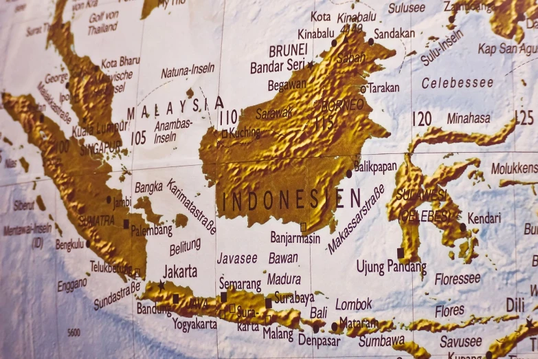 a close up of a map on a wall, a picture, shutterstock, sumatraism, many golden layers, ultra detailed close up, hyperrealistic, indonesia