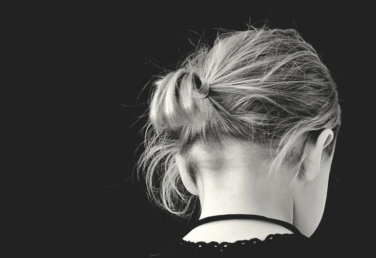 a black and white photo of a woman with her hair in a bun, pixabay, messy blond hair, back and white, a portrait of a suicidal girl, high resolution