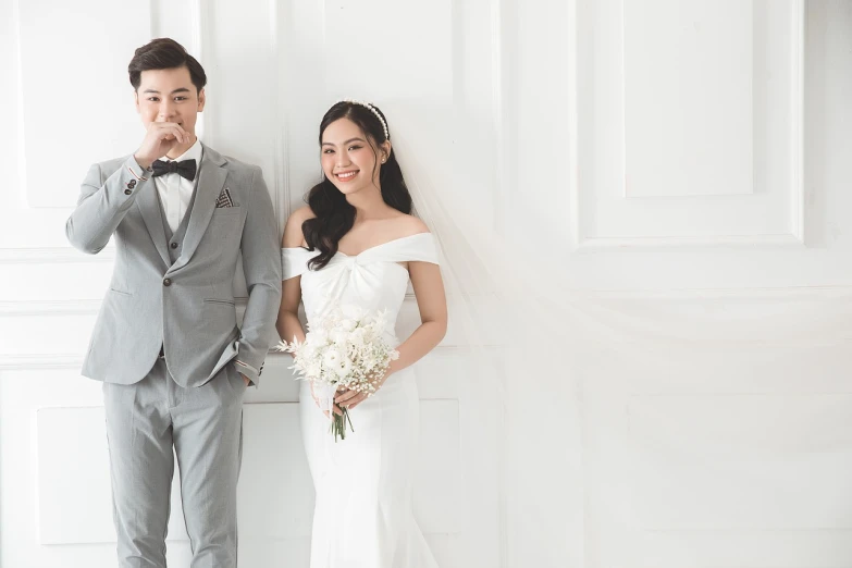 a bride and groom standing next to each other, by Ke Jiusi, white studio background, bright daylight indoor photo, marketing photo, 💣 💥